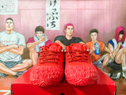 Front view of a pair of red Nike basketball shoes with lace-up closures.