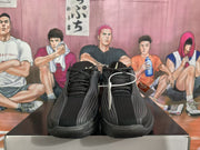 Front view of black Nike sneakers with textured uppers, black laces, and contrasting side details.