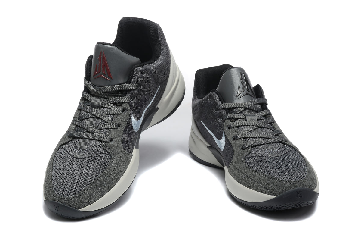 Pair of gray and black Jordan sneakers shown from a front three-quarter view.
