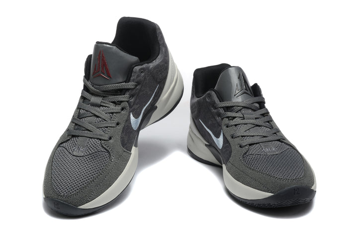 Pair of gray and black Jordan sneakers shown from a front three-quarter view.