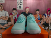 Front view of mint green Nike sneakers showing the textured uppers, matching laces and light-colored toe outsoles.