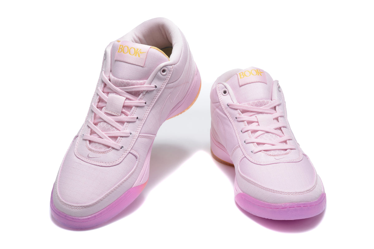 Pair of pink Nike mid-top sneakers shown from a front three-quarter angle.