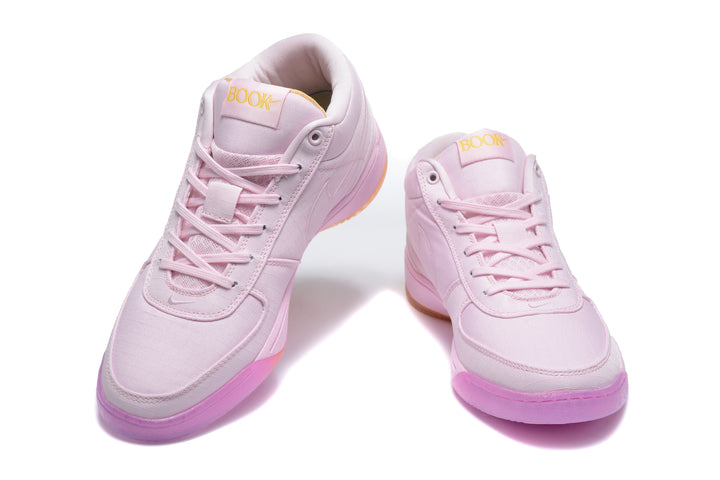 Pair of pink Nike mid-top sneakers shown from a front three-quarter angle.