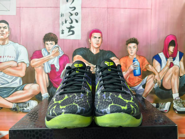 Front view of black basketball shoes with lime and purple accents