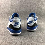 Rear view of both sneakers showing blue and white heel branding, blue collar lining, and gray outsoles.