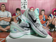Pair of grey and mint Nike basketball sneakers with horse and cloud graphics, shown from an angled side view on a box.