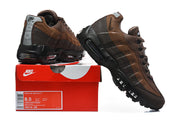 Brown Nike Air Max 95 TT sneakers beside a box with a visible product label.