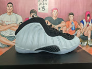 Side profile of a white and black high-top basketball sneaker with a sculpted upper and patterned side insert.