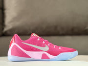 Side view of pink Nike Kobe 9 sneakers with silver Swoosh branding and a translucent outsole.