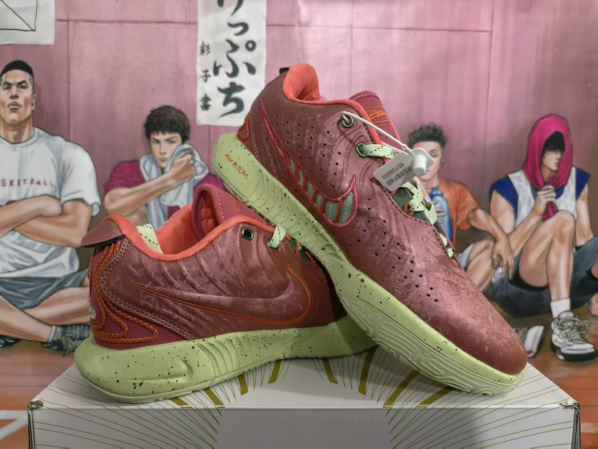 Pair of orange-red Nike sneakers shown from a three-quarter angle with pale green speckled soles and contrasting laces.