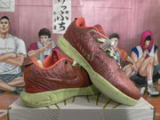 Pair of orange-red Nike sneakers shown from a three-quarter angle with pale green speckled soles and contrasting laces.