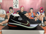 Side profile of a black Nike G.T. Cut 3 basketball shoe with patterned panels and silver, pale green, and orange accents.