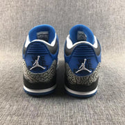 Rear view of the blue sneakers showing Jordan heel branding and elephant-print panels.