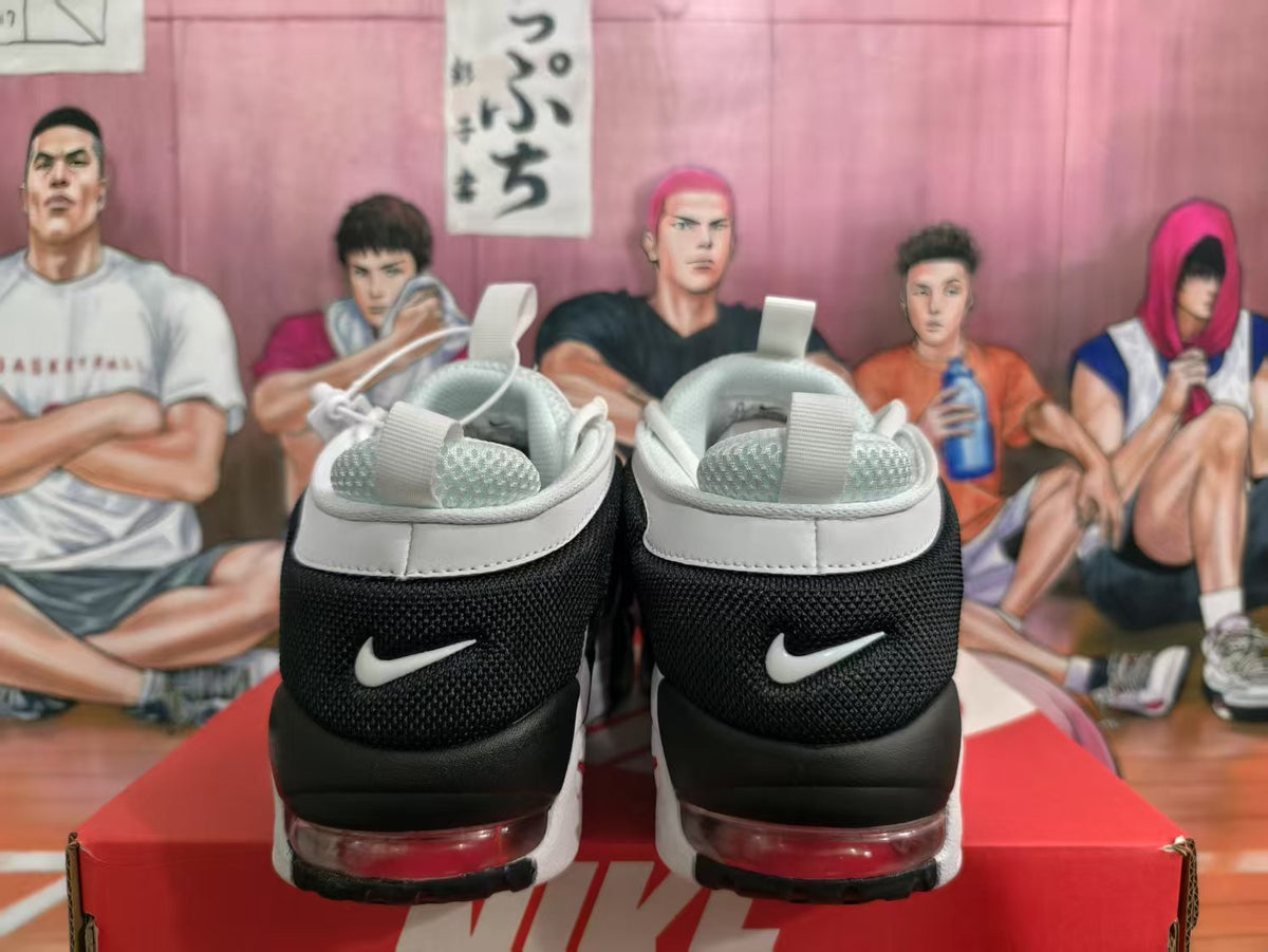 Rear view of white and black Nike sneakers showing heel branding and red-tinted sole cushioning.