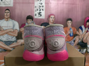 Rear view of pink high-top Nike basketball sneakers showing the ankle panels, decorative heel detailing, and bright pink outsoles.