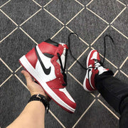 Angled view of a red, white, and black high-top sneaker showing the contrasting side Swoosh.