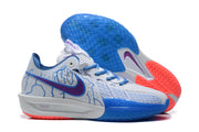 Angled view showing the patterned blue outsole, purple side swoosh, and coral traction sections.