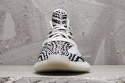 Front view highlighting the patterned toe box, white laces, and rounded off-white outsole.