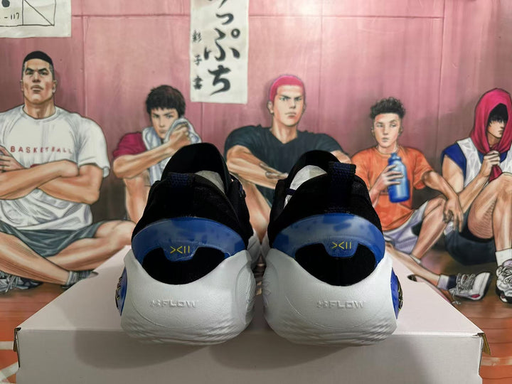 Rear view of black basketball shoes with white heels and blue heel accents