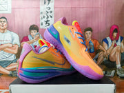 Pair of multicolor Nike basketball sneakers displayed on a shoebox, showing orange textured uppers, purple soles, blue laces, and green accents.