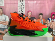 Side profile of an orange basketball sneaker with layered upper detailing, black midsole panels, and a bright green outsole.