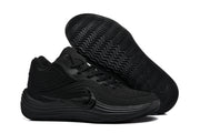 Side view of a black Nike sneaker with the outsole lifted to show its wavy tread pattern.
