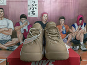 Front view of khaki Nike sneakers showing tonal laces, textured tongues and rounded toe boxes.