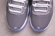 Close-up of the grey patent-style toe sections, white laces, and translucent blue outsole edges.