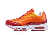 Side profile of an orange Nike Air Max 95 TT sneaker with a white midsole