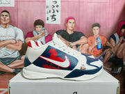 Side profile showing the navy and red graphic upper, white overlays, and white midsole.