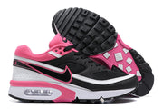 Side and outsole views of black, white and pink Nike Air Max BW-style sneakers.