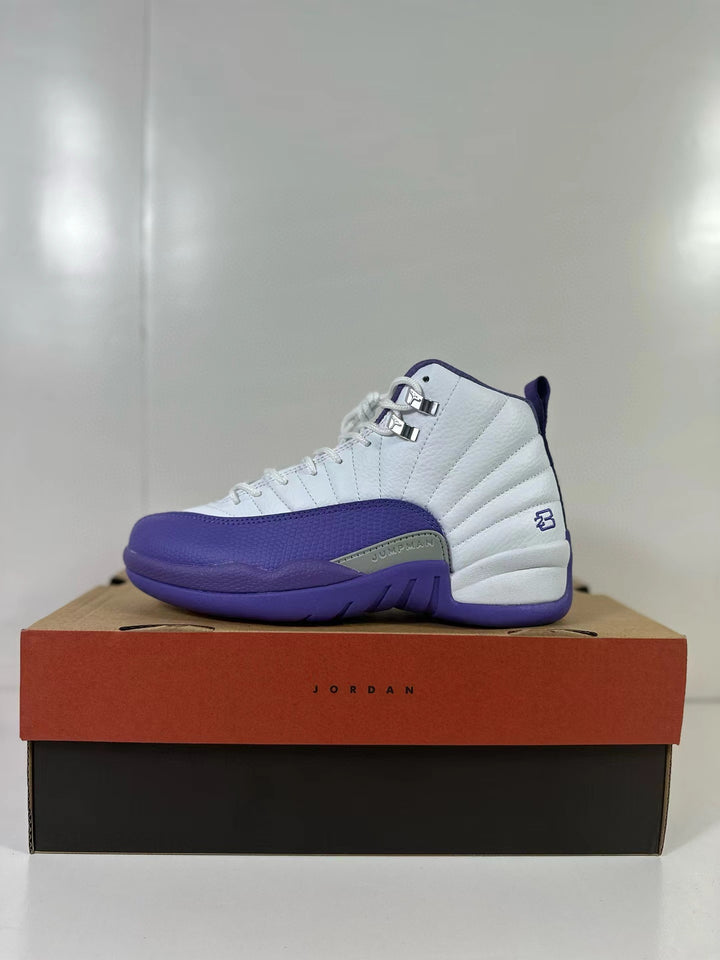 White and purple Air Jordan 12 Retro shown in profile on a shoebox