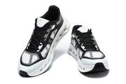 Pair of black and white On Cloudtilt Remix sneakers viewed from the front.
