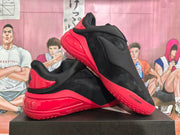 Pair of black and red sneakers shown from the side, highlighting the sculpted red sole and layered heel.