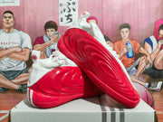 White and red basketball shoes shown from the side and outsole