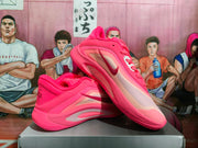 Angled view of pink Nike basketball shoes displaying the side branding and contrasting outsole sections.
