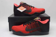 Pair of red and black Nike Kobe 11 basketball shoes displayed on a black shoebox.
