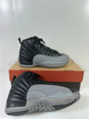 Angled view of the black and grey sneaker pair showing the outsole and side panels