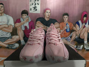 Front view of the pink Nike sneakers showing the perforated toe boxes, pink laces, and floral details on the translucent outsole.