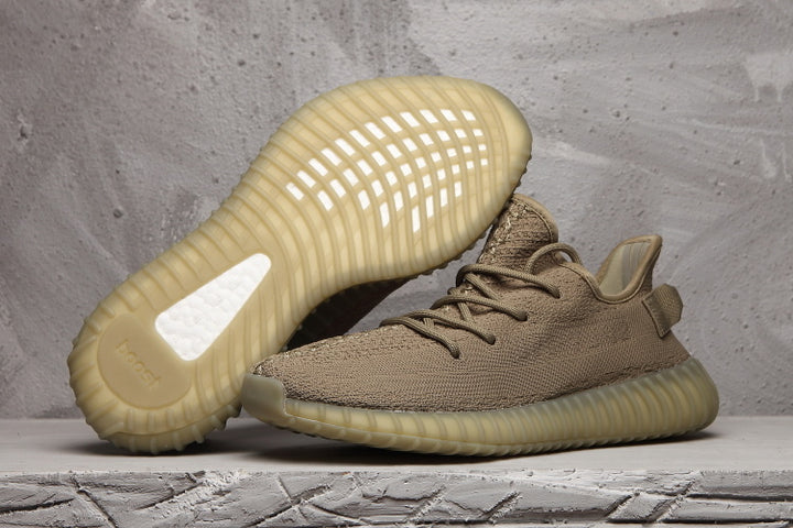 Pair of brown-tan 350 V2 style sneakers showing the woven upper and translucent ribbed soles.