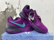 Pair of purple Nike basketball shoes with turquoise and pale green Swoosh accents