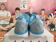 Rear view of sky-blue basketball sneakers with blue heel accents and white soles.