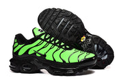 Nike Air Max Plus sneakers in vivid green and black, with the outsole visible.