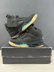 Pair of dark green and black Jordan Air Jordan 5 sneakers arranged on a shoe box, showing both outer sides.