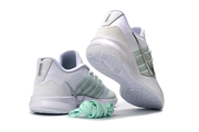 White and silver Nike Sabrina 3 shoes shown from the heel and outsole with spare mint laces