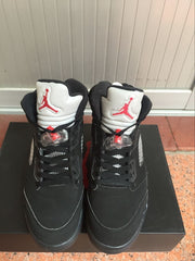 Front view of the pair showing black laces, white tongues, red Jordan graphics, and silver side details.