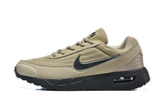 Side view of a tan Nike Air Max sneaker with a black Swoosh and sole.