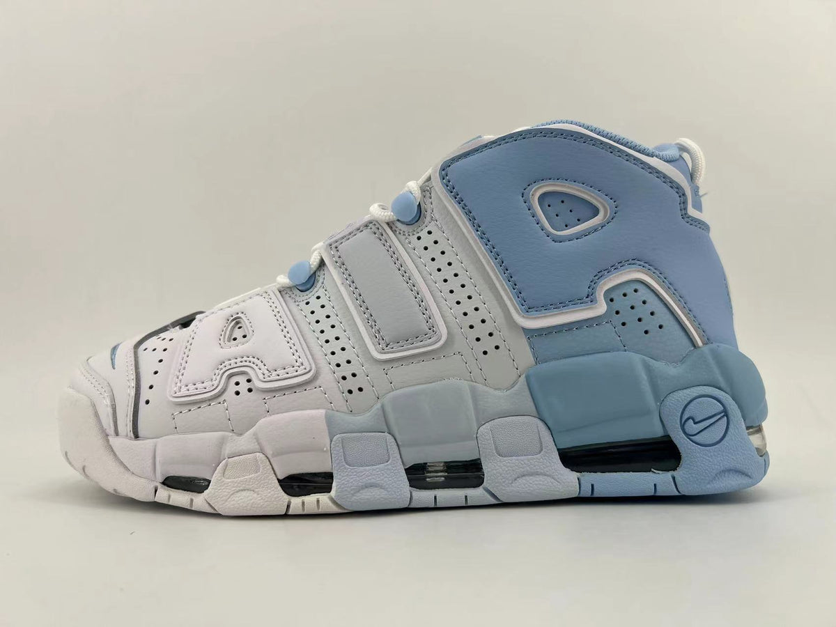 Side view of a white and light blue Nike Air More Uptempo high-top sneaker with perforated panels and oversized AIR lettering.