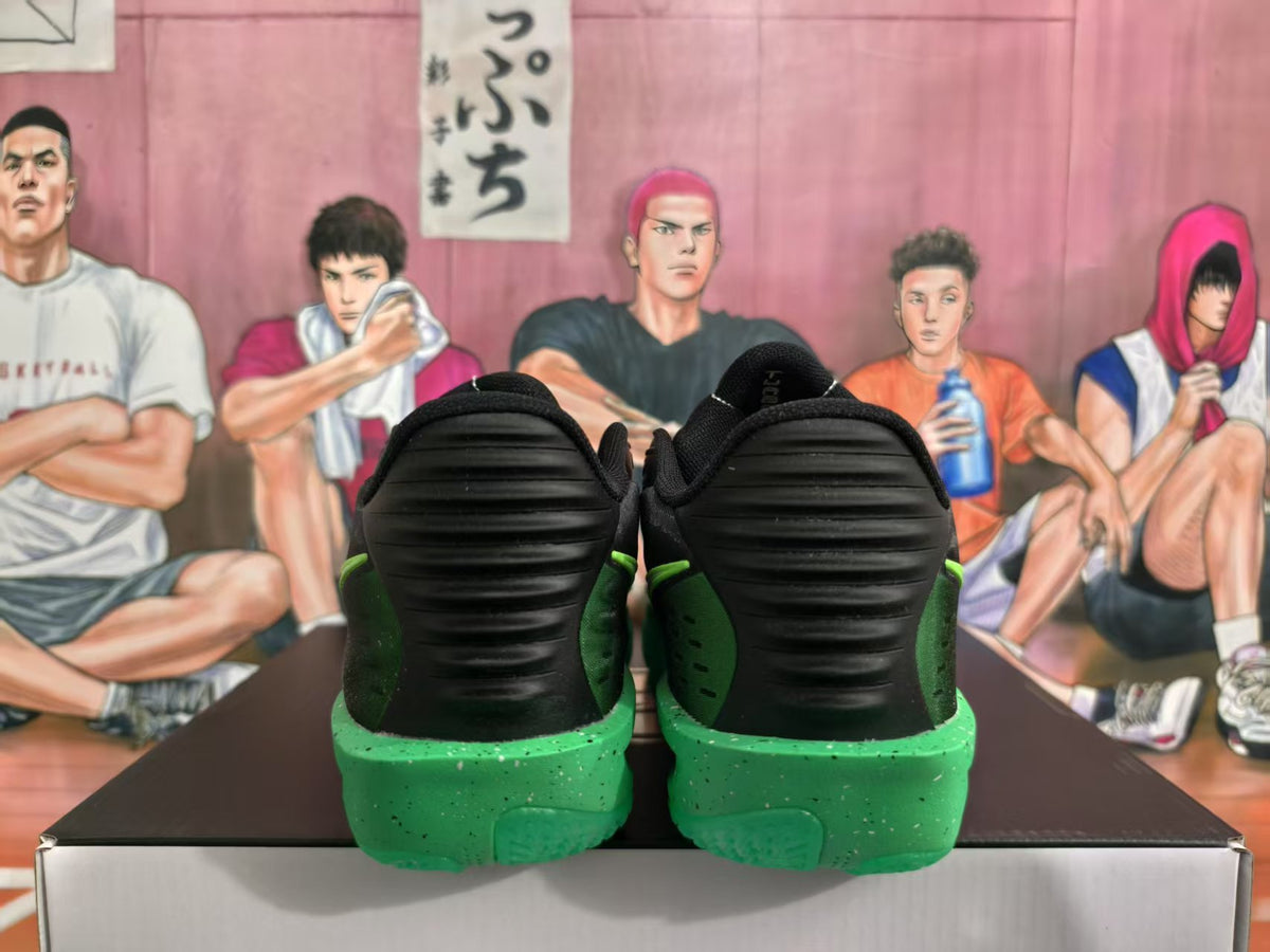 Rear view of black and green Nike basketball sneakers resting on a shoebox.