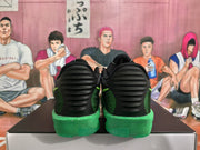 Rear view of black and green Nike basketball sneakers resting on a shoebox.